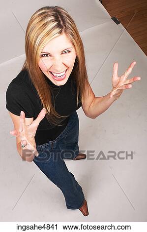 Young blond woman making an angry expression View Large Photo Image Stock Image - Young blond woman making an angry expression. Fotosearch