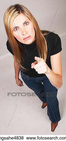 Young blond woman making an angry expression and pointing her finger View Large Photo Image Stock Photo - Young blond woman making an angry expression and pointing her finger. Fotosearch