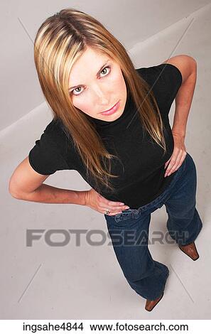 Young blonde woman standing with her hands on her hips View Large Photo Image Picture - Young blonde woman standing with her hands on her hips. Fotosearch