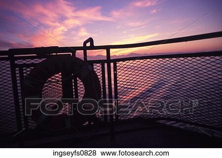 Stock Photo - Boat on the Ocean at Sunset. Fotosearch