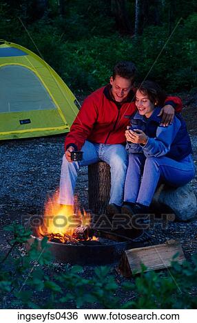 Stock Photograph - Couple by the Campfire. Fotosearch