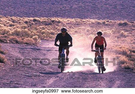 Couple Mountain Biking Together View Large Photo Image Stock Photo - Couple Mountain Biking Together. Fotosearch