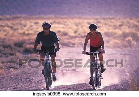Couple Mountain Biking Together View Large Photo Image Stock Photo - Couple Mountain Biking Together. Fotosearch