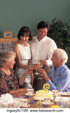 Couple with Parents Toasting Each Other View Large Photo Image Stock Photo - Couple with Parents Toasting Each Other. Fotosearch