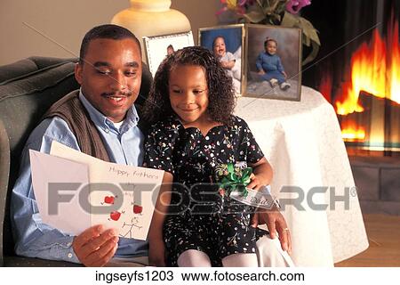 Stock Image - Father and Daughter Looking at Valentine. Fotosearch
