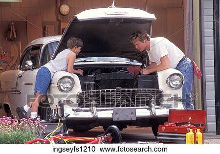 Stock Image - Father and Son Working on Car. Fotosearch