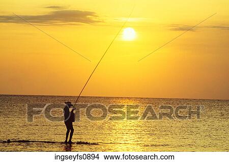 Fishing in the Sea at Sunset View Large Photo Image Picture - Fishing in the Sea at Sunset. Fotosearch