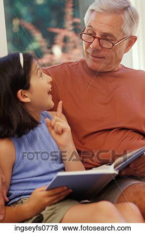 Grandpa Reading with Granddaughter View Large Photo Image Stock Photo - Grandpa Reading with Granddaughter. Fotosearch