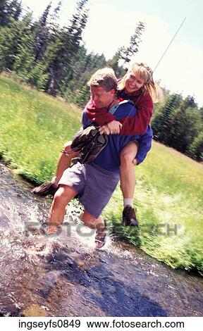 Happy Couple Fording a Stream View Large Photo Image Stock Photo - Happy Couple Fording a Stream. Fotosearch