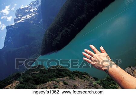 Stock Image - Hiking High Above a Blue River. Fotosearch