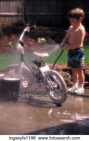 Little Boy Hosing Off a Bike View Large Photo Image Stock Photograph - Little Boy Hosing Off a Bike. Fotosearch