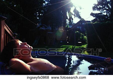 Little Boy Relaxing in Backyard Pool View Large Photo Image Stock Photo - Little Boy Relaxing in Backyard Pool. Fotosearch