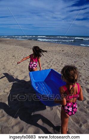 Little Girls Playing With a Boat at the Beach View Large Photo Image Stock Image - Little Girls Playing With a Boat at the Beach. Fotosearch
