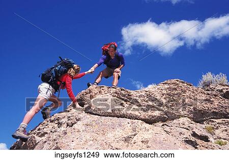 Stock Photo - Man and Woman Rock Climbing. Fotosearch