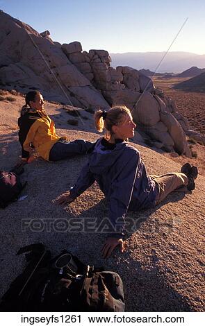 Man and Woman Sitting on Rock Together View Large Photo Image Stock Image - Man and Woman Sitting on Rock Together. Fotosearch