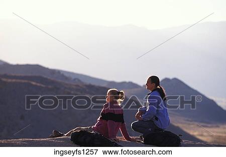 Man and Woman Sitting on Rock Together View Large Photo Image Stock Photo - Man and Woman Sitting on Rock Together. Fotosearch