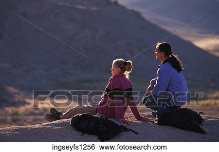 Man and Woman Sitting on Rock Together View Large Photo Image Stock Photograph - Man and Woman Sitting on Rock Together. Fotosearch