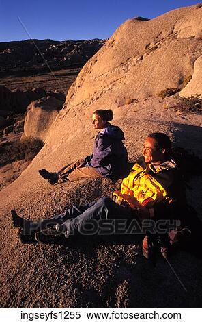 Man and Woman Sitting on Rock Together View Large Photo Image Stock Photography - Man and Woman Sitting on Rock Together. Fotosearch