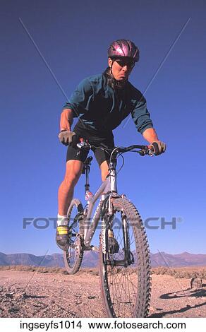 Picture - Man Doing Trick on Mountain Bike. Fotosearch
