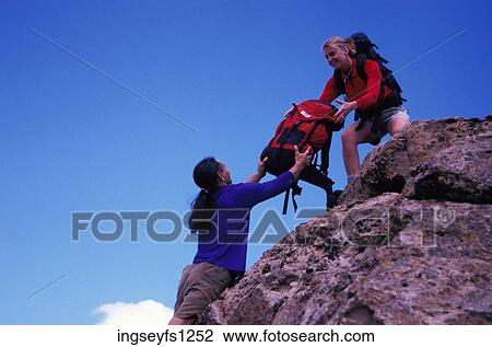 Man Handing Woman a Backpack View Large Photo Image Stock Image - Man Handing Woman a Backpack. Fotosearch