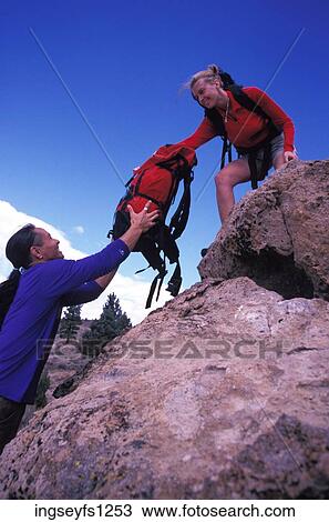 Man Handing Woman a Backpack View Large Photo Image Stock Image - Man Handing Woman a Backpack. Fotosearch