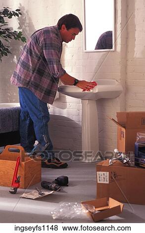 Stock Photo - Man Installing a Sink. Fotosearch