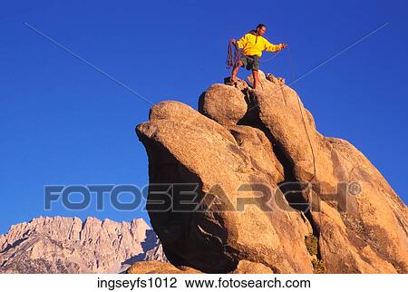 Stock Image - Man Rock Climbing. Fotosearch