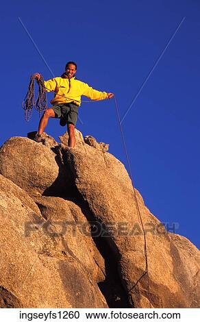 Stock Image - Man Rock Climbing. Fotosearch