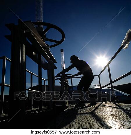 Stock Photo - Man Turning Valve Wheel. Fotosearch