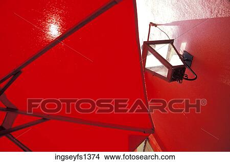 Picture - Red Umbrella and Light Fixture on Wall. Fotosearch