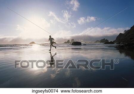 Running on the Beach at Sunset View Large Photo Image Picture - Running on the Beach at Sunset. Fotosearch