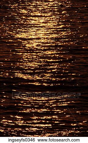 Stock Photograph - Sunset Reflecting on Water. Fotosearch