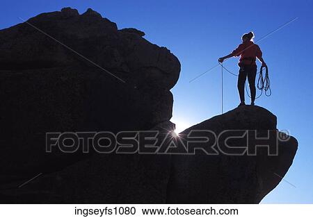 Stock Image - Woman Rock Climbing. Fotosearch
