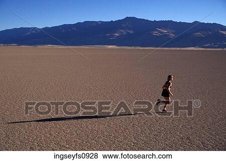 Woman Running on Dry Baked Mud View Large Photo Image Stock Photo - Woman Running on Dry Baked Mud. Fotosearch