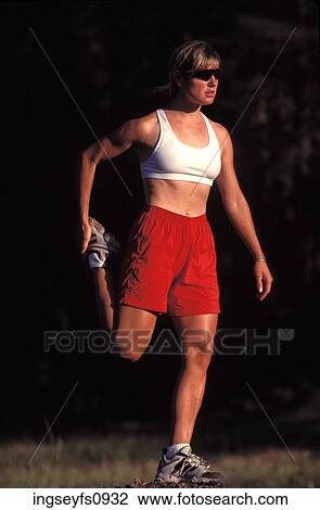 Stock Image - Woman Stretching Before Exercising. Fotosearch