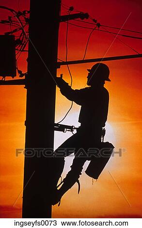 Stock Image - Worker on Power Pole. Fotosearch