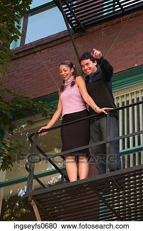 Young Couple on Fire Escape Waving View Large Photo Image Stock Image - Young Couple on Fire Escape Waving. Fotosearch