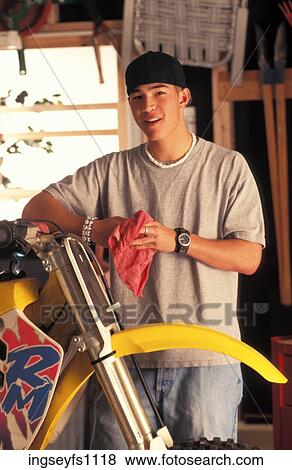 Young Man Working on Motorcycle View Large Photo Image Stock Photo - Young Man Working on Motorcycle. Fotosearch