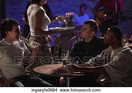 Picture - Young Men Checking Out the Waitress. Fotosearch