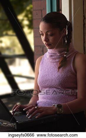 Young Woman Typing at a Windowsill View Large Photo Image Stock Photograph - Young Woman Typing at a Windowsill. Fotosearch
