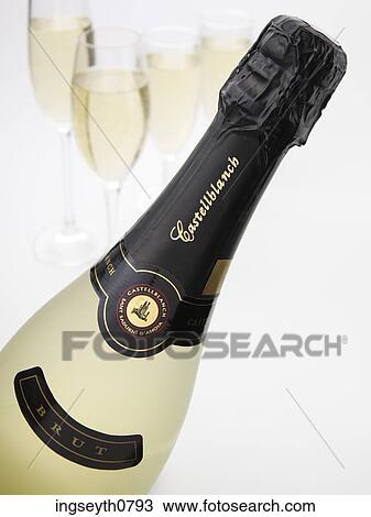 Stock Image - Bottle and a glass of red wine. Fotosearch