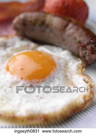 Stock Image - Bottle and a glass of red wine. Fotosearch