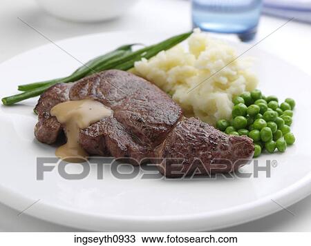 Stock Image - Bottle and a glass of red wine. Fotosearch