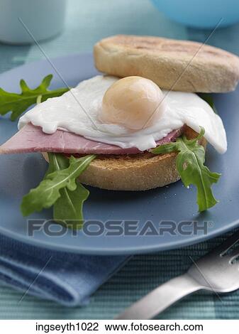 Stock Image - Bottle and a glass of red wine. Fotosearch