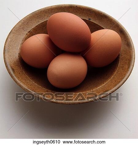 Stock Image - Eggs, egg bowl, four, four eggs, free range, battery farm, chicken. Fotosearch