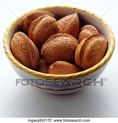 Stock Image - food, nuts, nuts in shell, almonds in shell, bowl of nuts, diet, almonds in sheel. Fotosearch