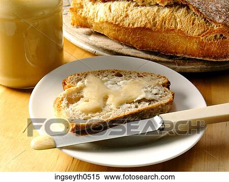 Stock Photography - Honey, bread, bread & honey, plate, continental breakfast, knife, food. Fotosearch