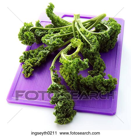 Stock Image - parsley, curly parsely, bunch of parsley, chopping board, food, diet, nutritian. Fotosearch