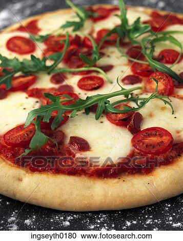 Stock Image - pizza, deep base pizza, margarita pizza, mozzarella, tomato, arugula, rocket. Fotosearch