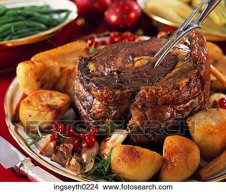 Picture - roast beef, beef, carrots, green beans, roast potatoes, horseradish, platter. Fotosearch